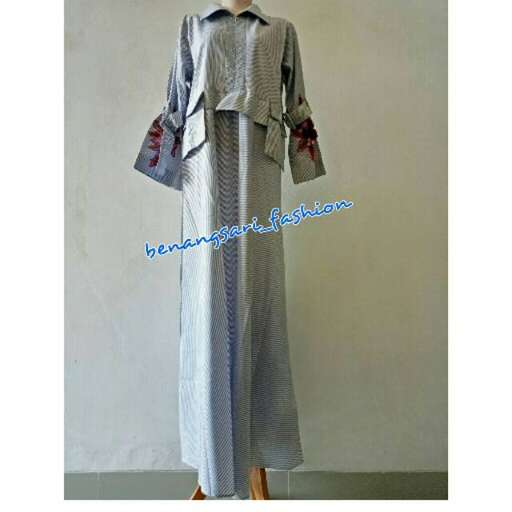 a long sleeved dress with a collar and a belt.