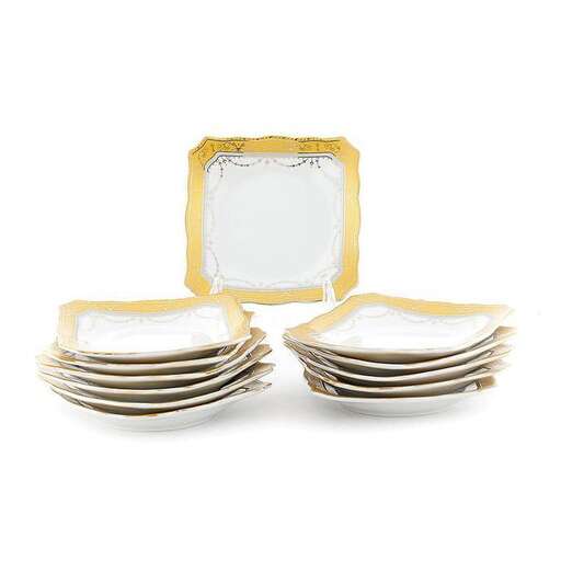 a stack of white plates with gold trim