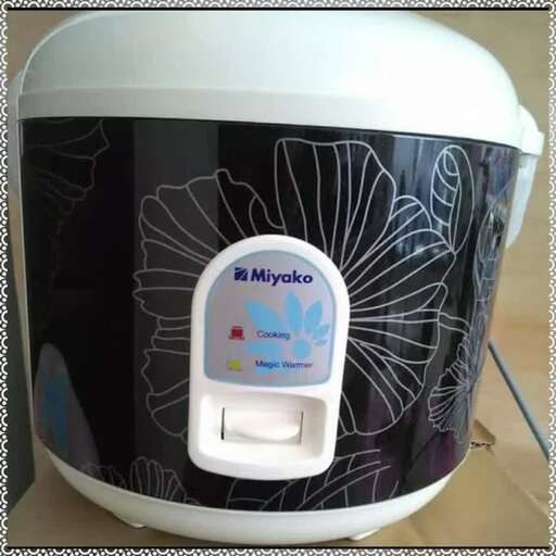 a white and black blender with a white handle.