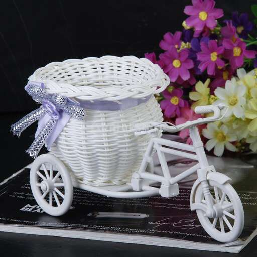 a basket of flowers made from a bicycle.