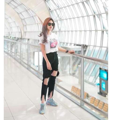 a girl standing on a railing in an airport.