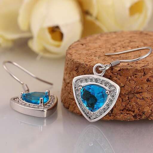 a beautiful blue sapphire and diamond earrings set in sterling silver.