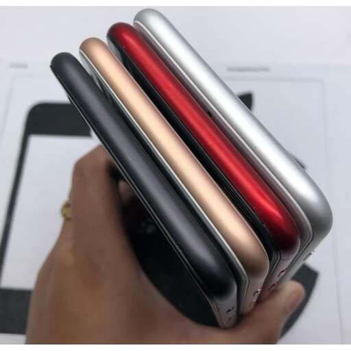 a person holding two cell phones in their hand.