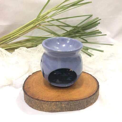 a blue vase with a black lid and some branches in it