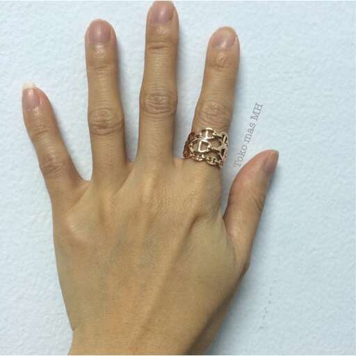 a woman's hand with a gold ring on it.