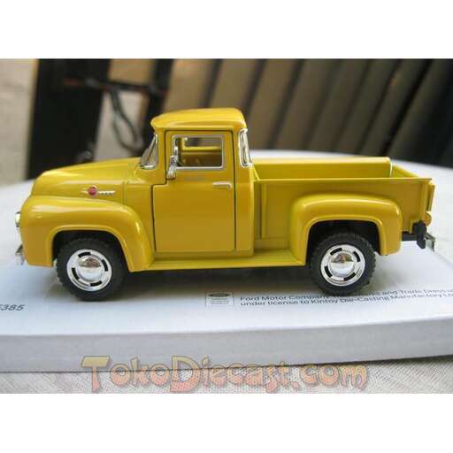 a yellow truck cake with a black roof.