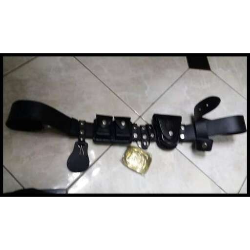 a camera strap with a small gold coin.