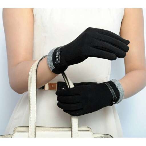 a woman wearing a white dress and black gloves.