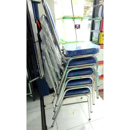 a stack of chairs sitting on top of a white floor.