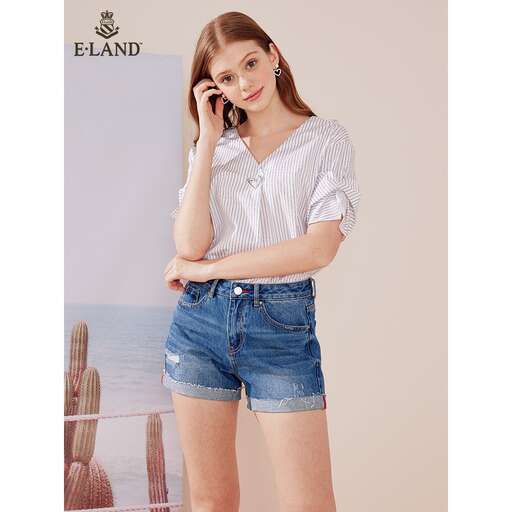 a woman wearing shorts and a white shirt