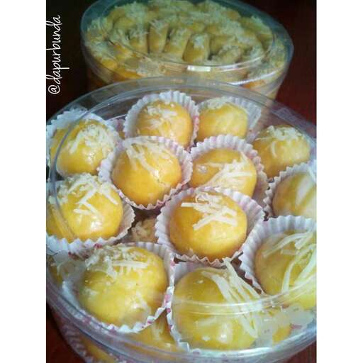 a selection of mini cupcakes in a plastic box.