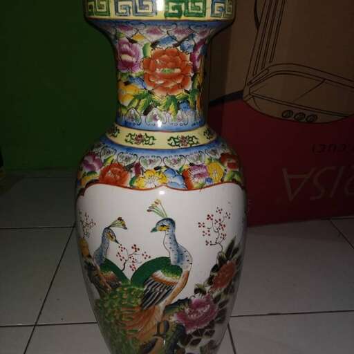 a large vase with a painted design on it.