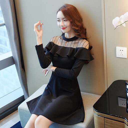 a woman in a black dress smoking a cigarette