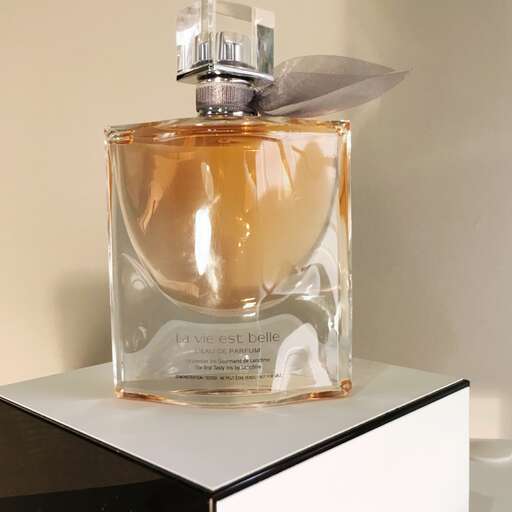 a bottle of perfume sitting on a table.