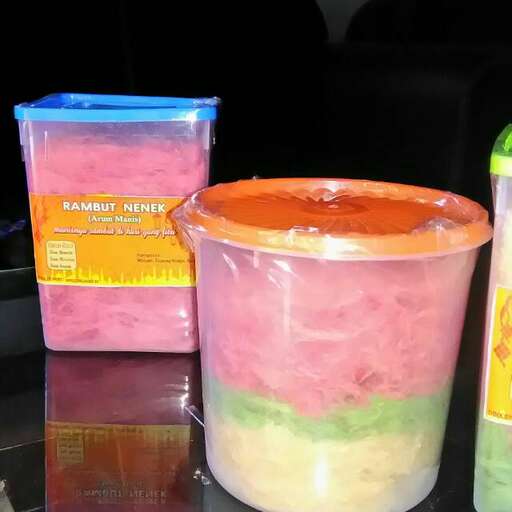 a table topped with plastic containers filled with different colored liquid.