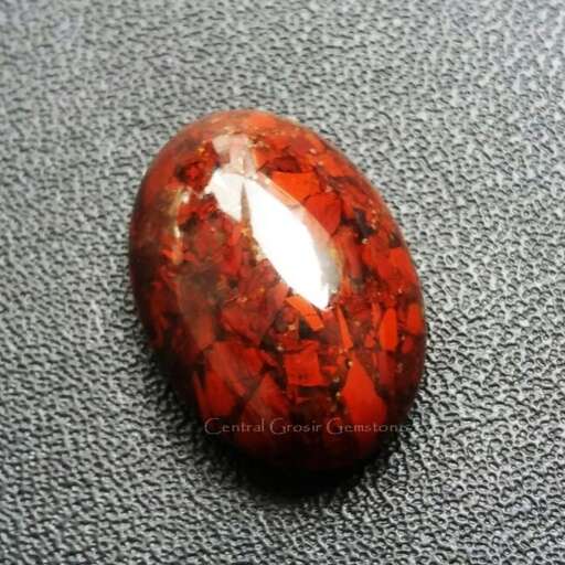a beautiful red and orange marble with a white spot on the center.