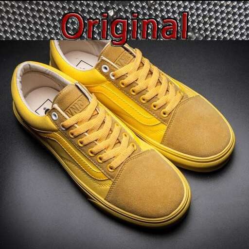 a pair of yellow canvas shoes with a black background.