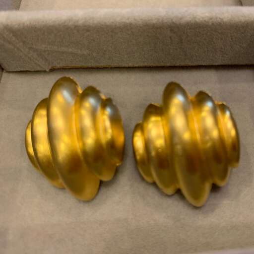 a pair of gold plated earrings