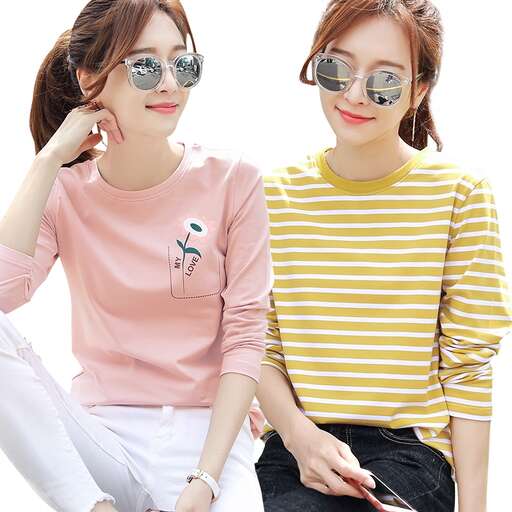 women in glasses sitting on a bed