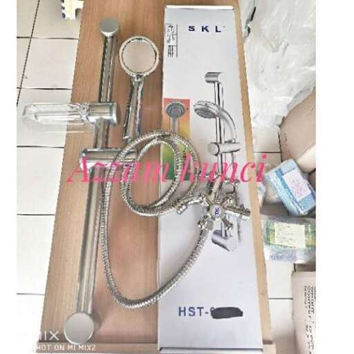 a wooden table with a set of keys and a bottle