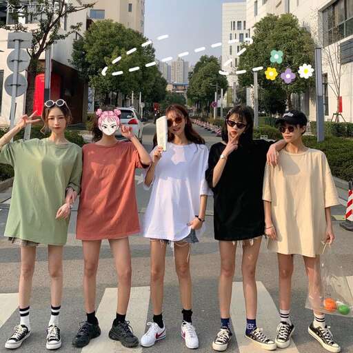 four people standing on a sidewalk with a skateboard.