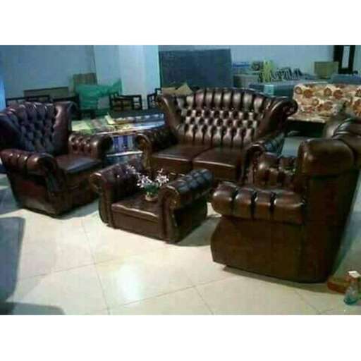 a set of leather chairs in a room.
