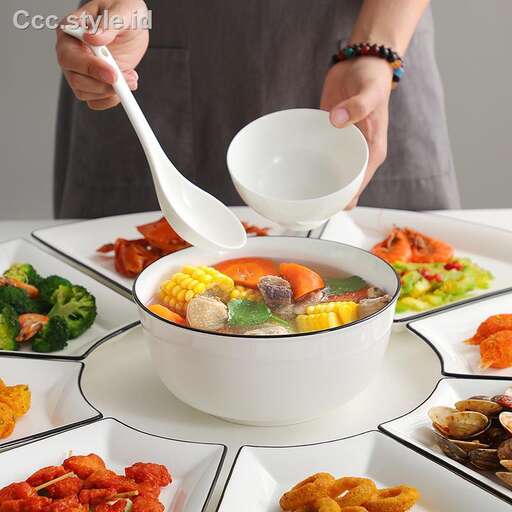 a person is pouring a spoon into a bowl of soup.