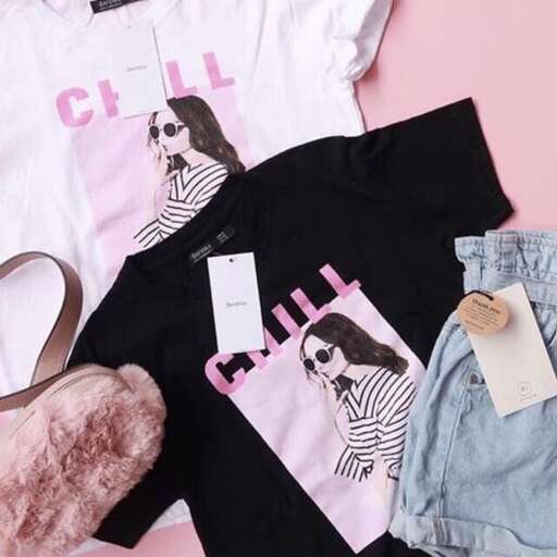 a pile of clothes sitting on top of a pink wall.