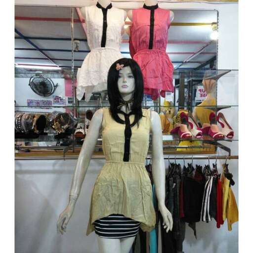 a mannequin with a black and white striped dress and black striped skirt.
