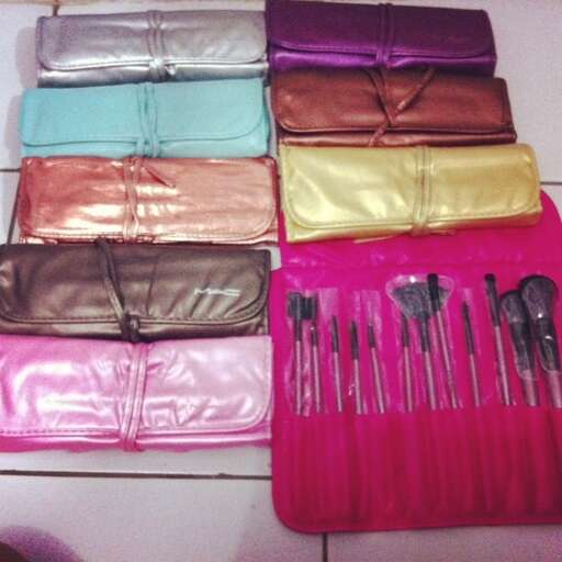 a bunch of different colored leathers sitting on a pink surface.