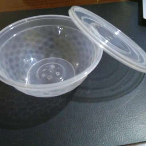 a plastic container with a lid on a counter top.