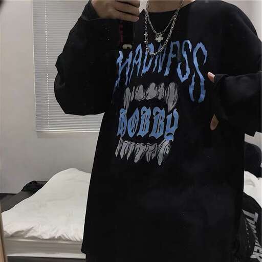 a person in a black shirt holding a cell phone.