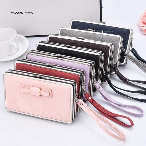 a small purse with a laptop and a cup on top of it.