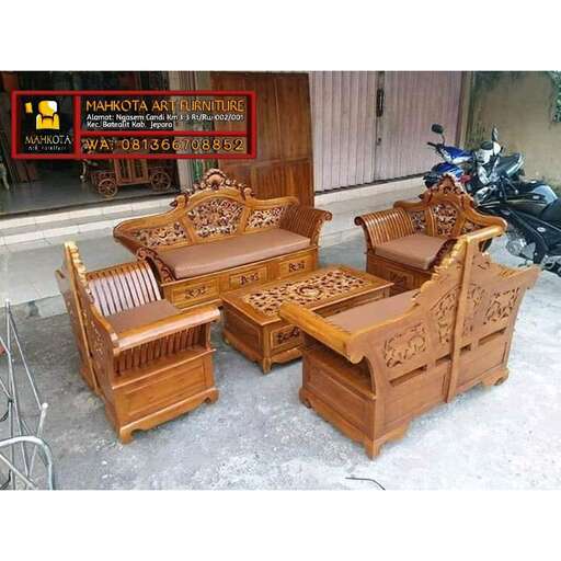 a pair of wooden chairs in a storefront.