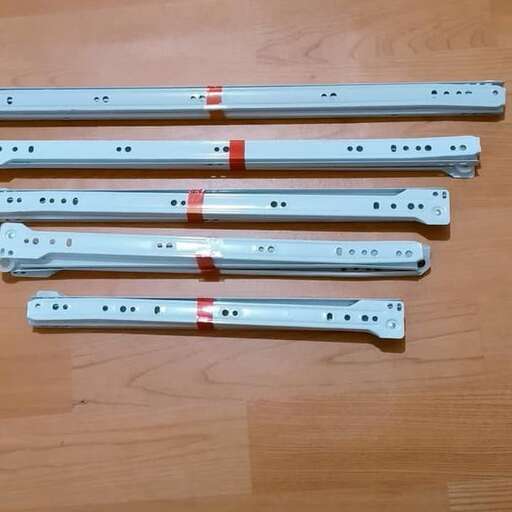 a set of metal screws with a red stripe.