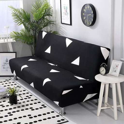 a black and white checkered couch with a plant on it.
