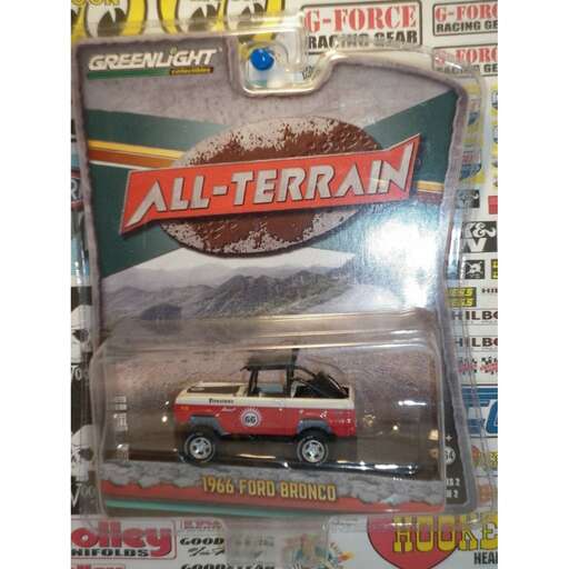 a toy car with a mountain in the background