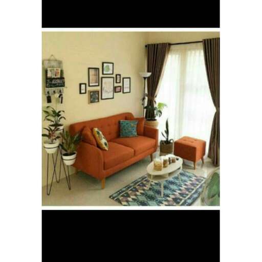 a living room with a couch, table, and pictures on the wall.