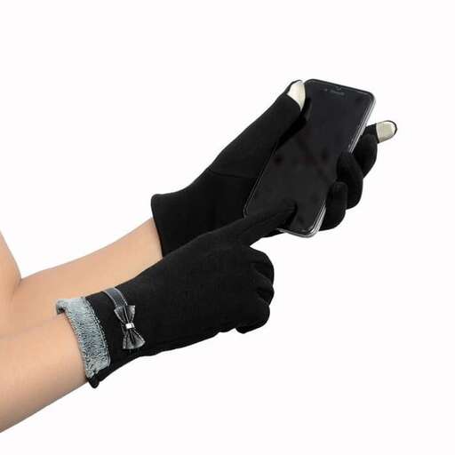 a person wearing gloves holding a cell phone.