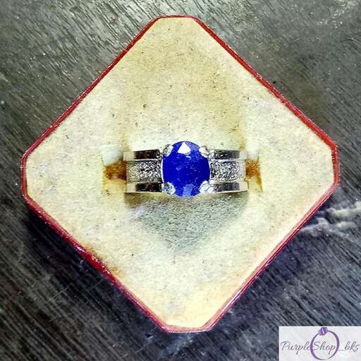 a ring with a blue sapphire and diamond.