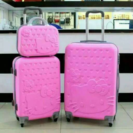 pink suitcases with a tag