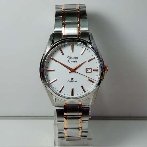 a watch with a gold band on a white surface.