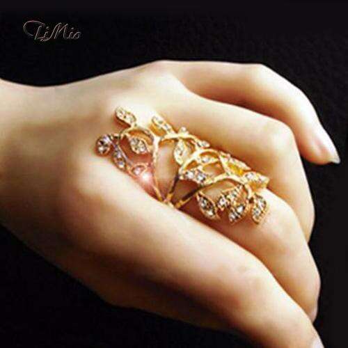 a ring with a gold leaf and diamonds