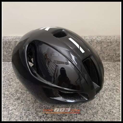 a black helmet on a grey surface.