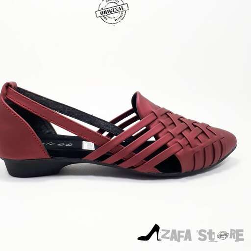 a pair of black leather sandals with a touch of red