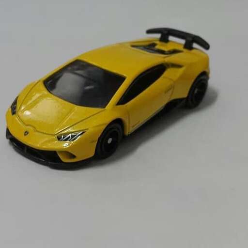a yellow car with a black roof and a black roof.