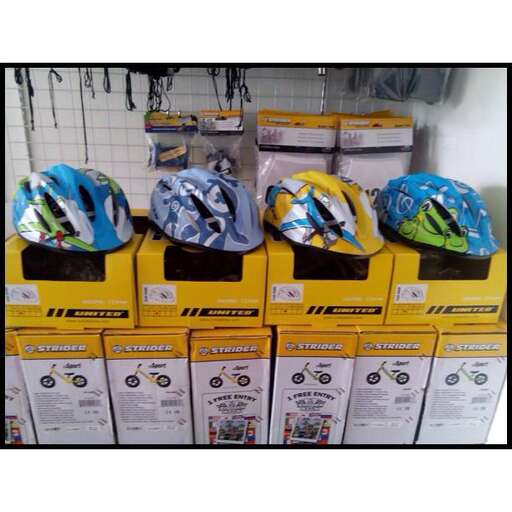 a bunch of helmets on top of boxes in a store.