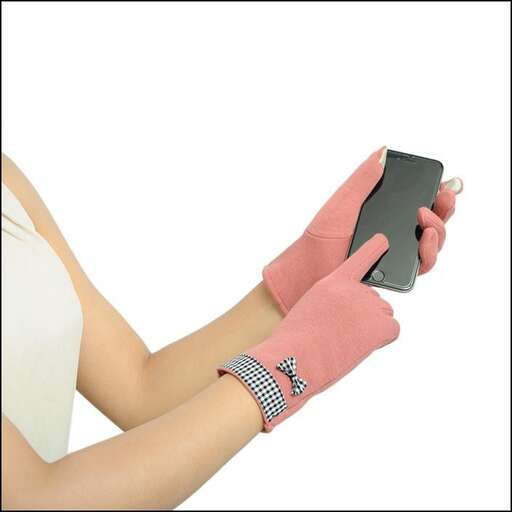 a woman holding a cell phone in her hands.