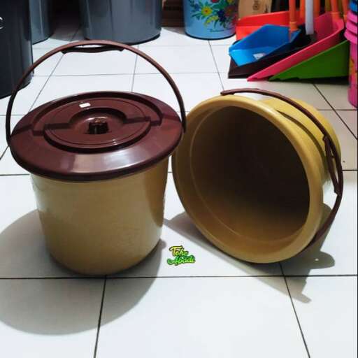 a pot and a bowl on a tiled floor.