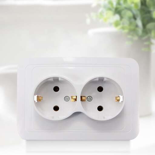 a white electric outlet with two plugs.